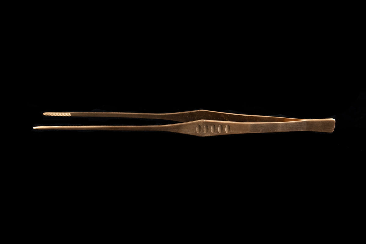 Straight plating tweezers in a pink gold finish with precision tips and an ergonomic grip displayed against a black background