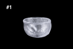 Handmade silver toned glass guinomi sake cup with a frosted textured surface and rounded rim against a black background