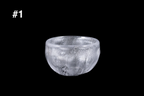 Handmade silver toned glass guinomi cup with a rounded bowl shape and shimmering textured surface displayed against a black background