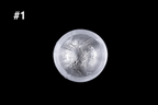 Translucent silver glass sake cup with a textured snowflake like pattern and softly rounded rim displayed against a black background