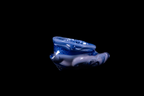 Handmade blue glass vessel with sculptural wave-like contours, glossy cobalt and pale lavender swirls, and an irregular open rim against a black background