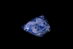 Bottom view of a handmade blue glass vessel with layered cobalt and pale lavender swirls and sculpted knobs against a black background