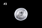 Small handmade silver toned guinomi glass cup viewed from above with a bright white silver finish and richly textured interior against a black background