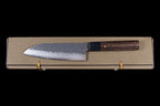 Gen 150mm Kurouchi Santoku, left side of the blade, lying on its box, viewed from above