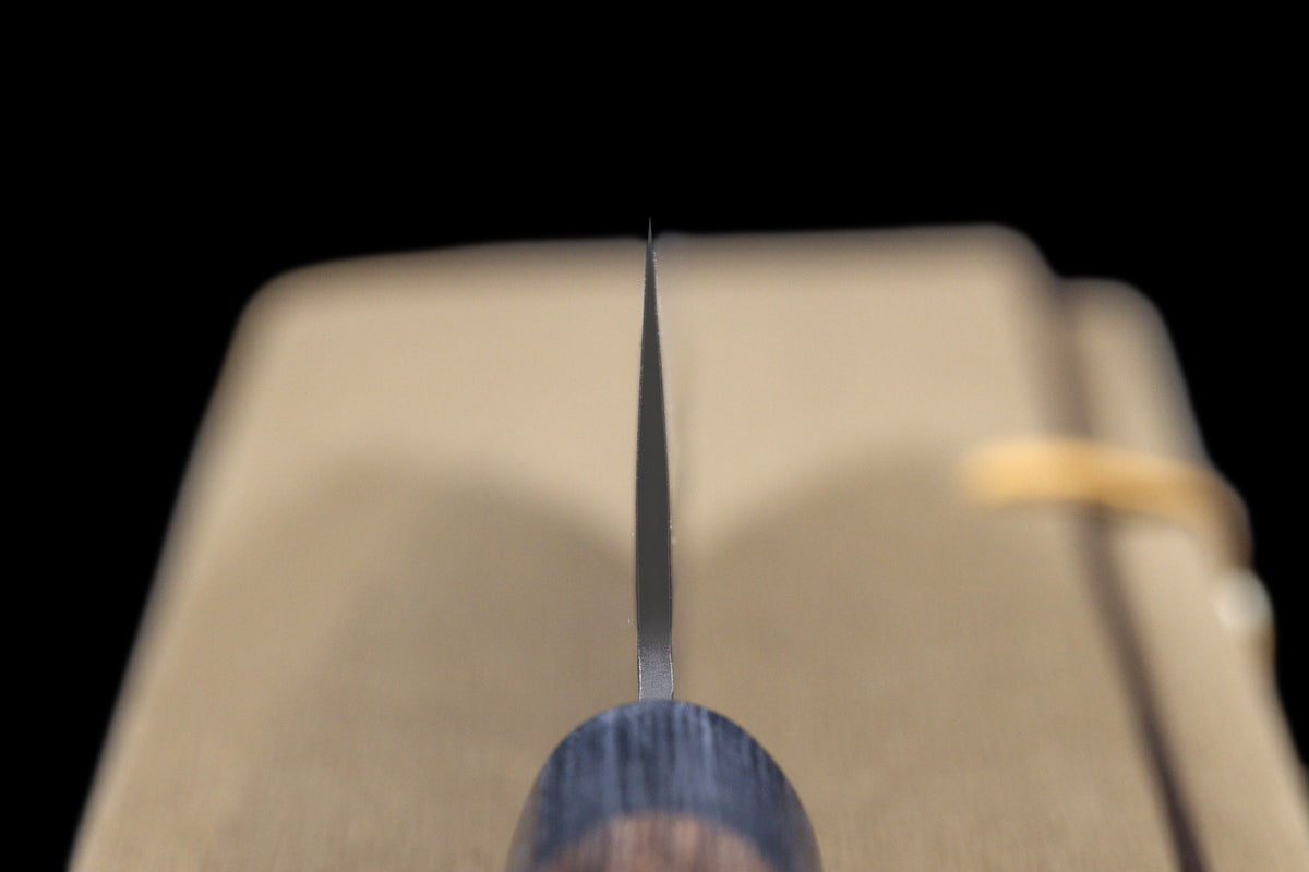 Gen 150mm Kurouchi Santoku, choil view head-on, showing blade thickness from edge to spine