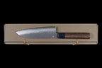 Gen 150mm Kurouchi Santoku, right side of the blade with maker's mark, lying on its box, viewed from above