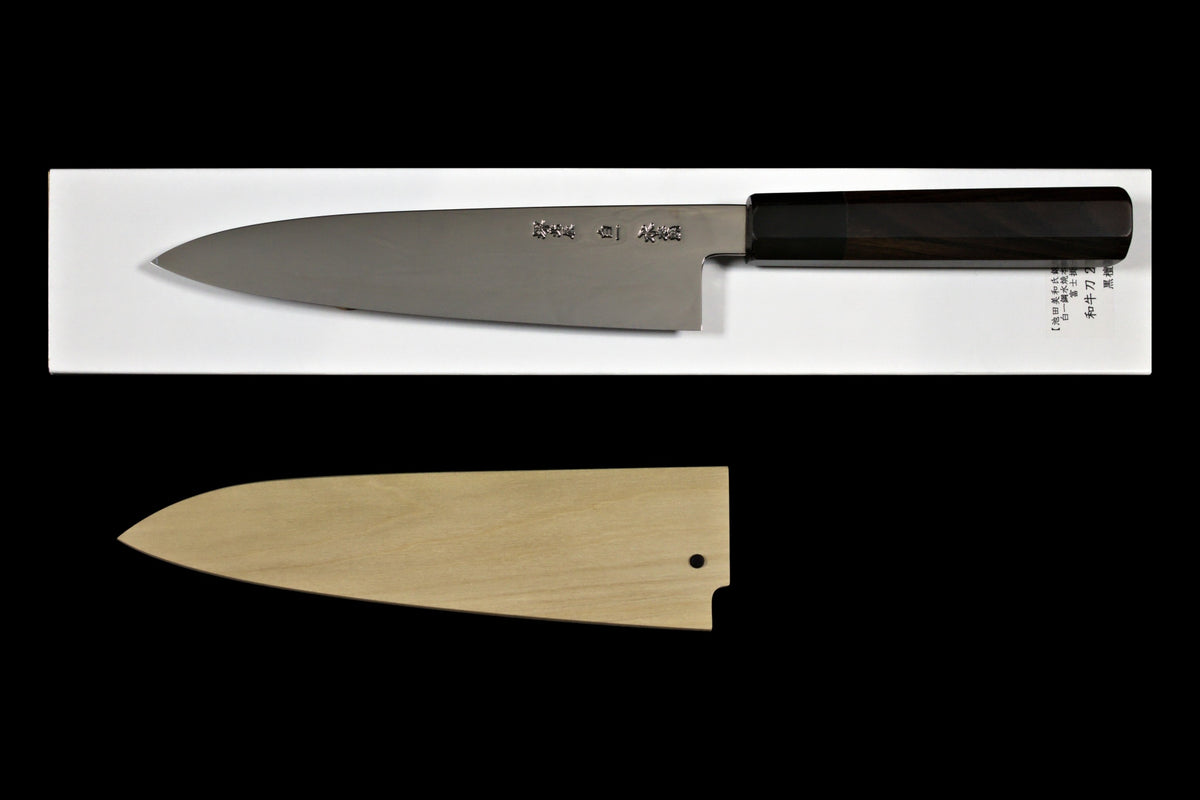 Back side of the Gesshin Uraku 210mm White #1 Mizu Honyaki Wa-Gyuto showing kanji, on its box with saya below