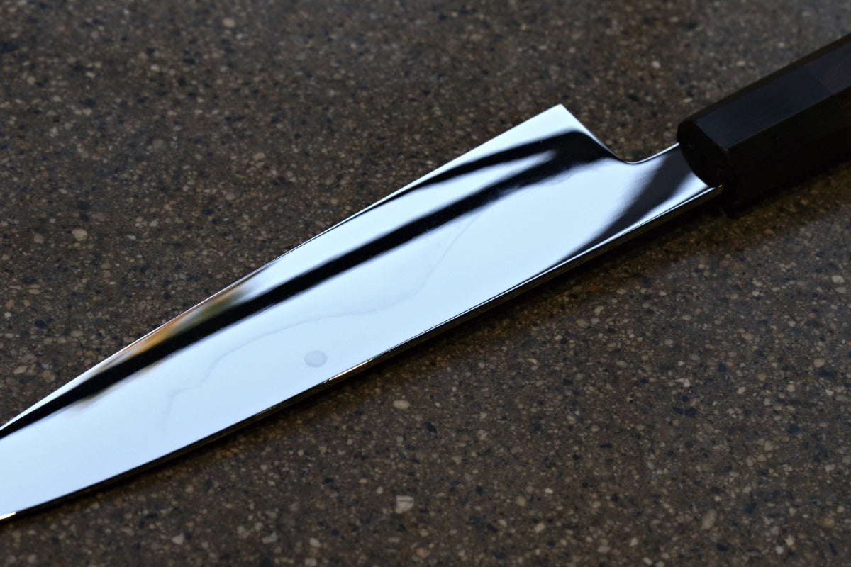 Close-up of the mirror-polished blade toward the tip of the Gesshin Uraku 210mm White #1 Mizu Honyaki Wa-Gyuto