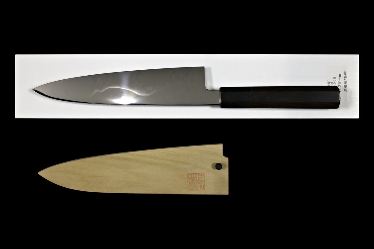 Gesshin Uraku 210mm White #1 Mizu Honyaki Wa-Gyuto with visible hamon on its white box, with magnolia saya below