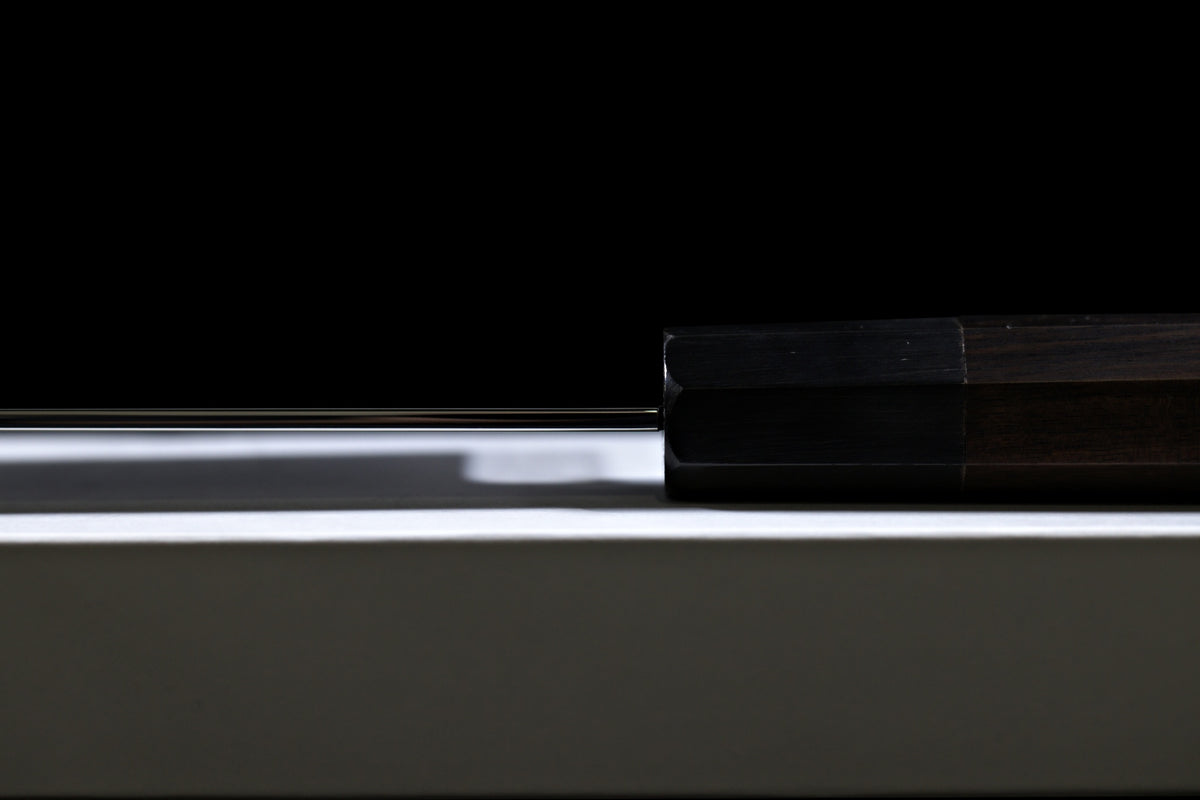 Side view of the spine, ferrule and octagonal handle of the Gesshin Uraku 210mm White #1 Mizu Honyaki Wa-Gyuto