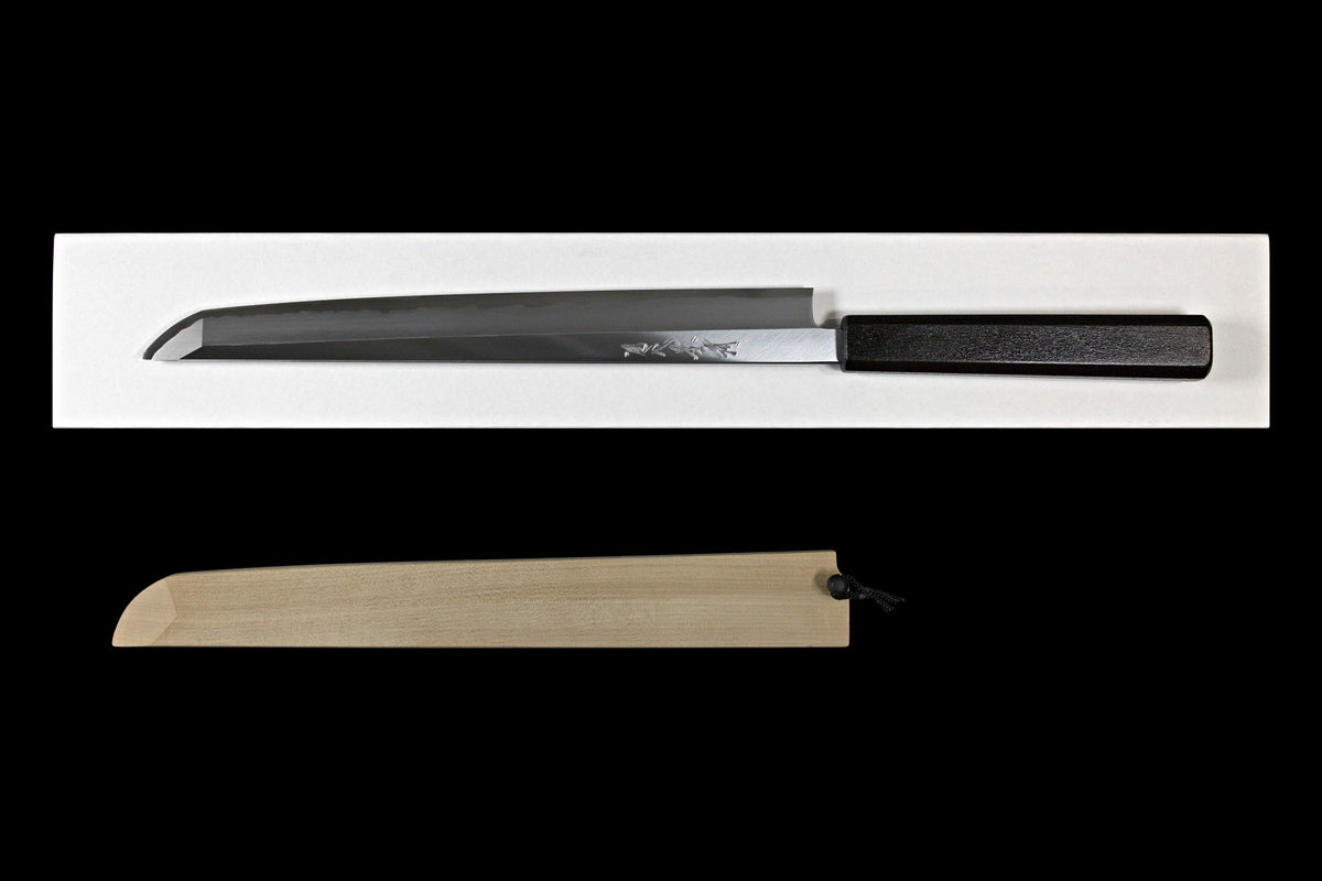 Gesshin Kagekiyo 270mm White #2 Shinogi-Ari Sakimaru Takobiki, front side with engraved maker's signature and matte black lacquer handle, shown on its box with ho wood saya below