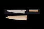 Gesshin Ginga 210mm carbon wa gyuto by Ashi Hamono with polished blade and ho wood handle above its matching wooden saya on a black background